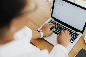 Person typing on a laptop at a desk
