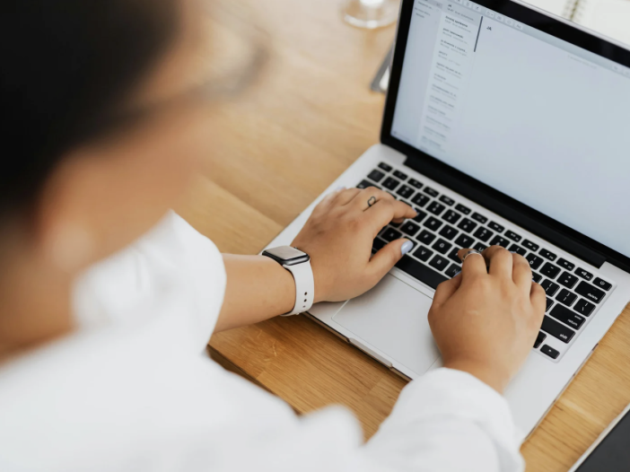 Person typing on a laptop at a desk