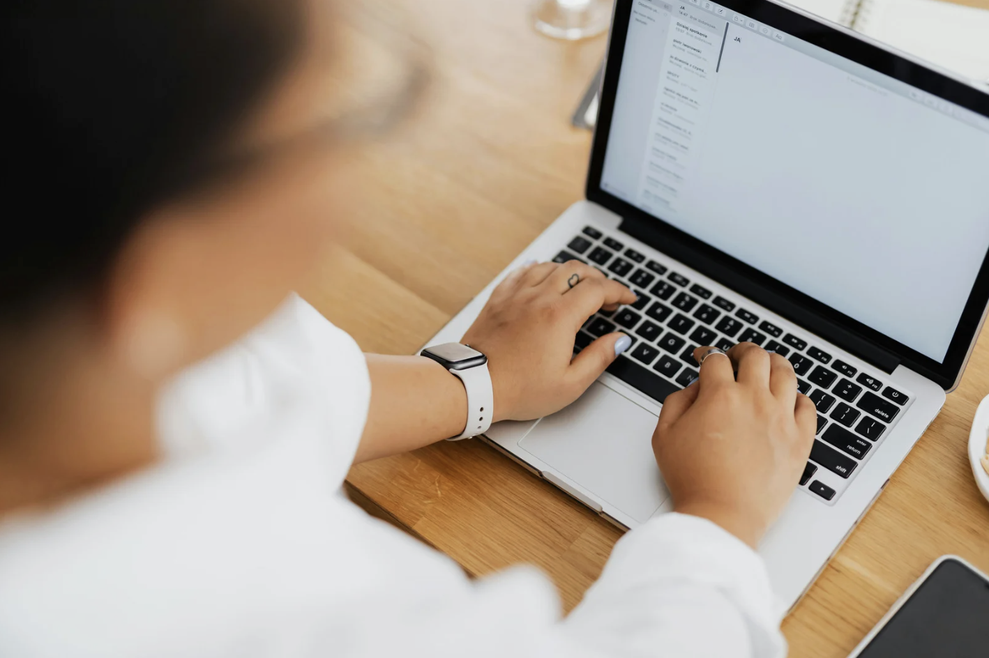 Person typing on a laptop at a desk
