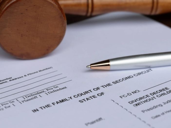 final decree of divorce document with wooden gavel and pen on desk
