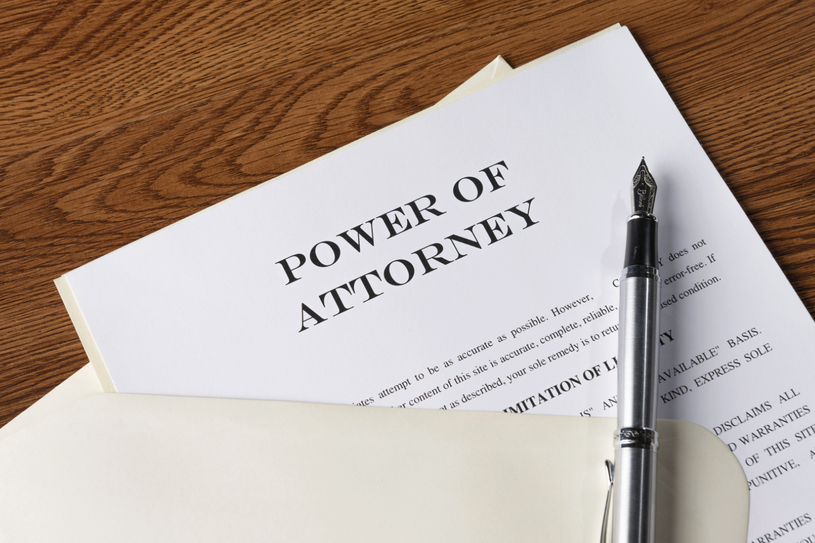 A power of attorney document and fountain pen on a wooden desk