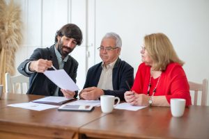 Financial advisor and client reviewing documents together at a desk