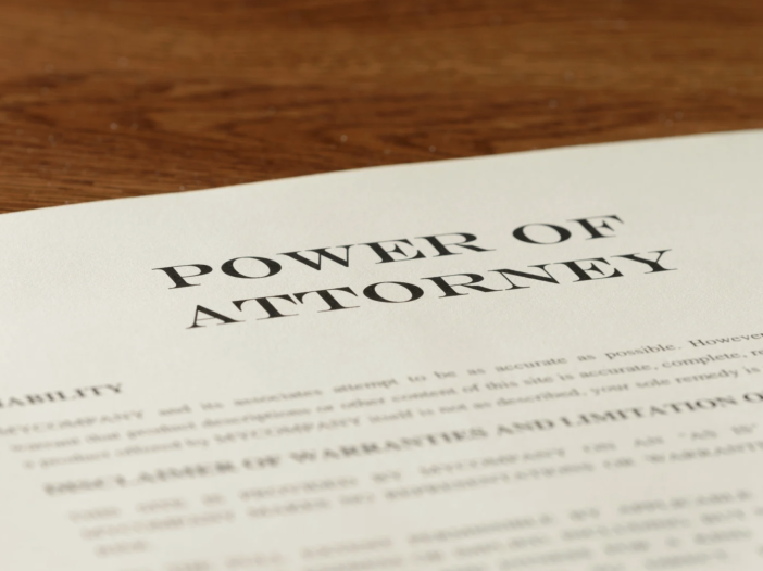 Spower of attorney document sitting on a desk, There are several types of power of attorney, each covering a different kind of authority.