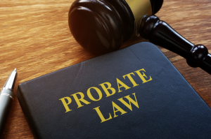 A probate law book next to a judge's gavel and pen